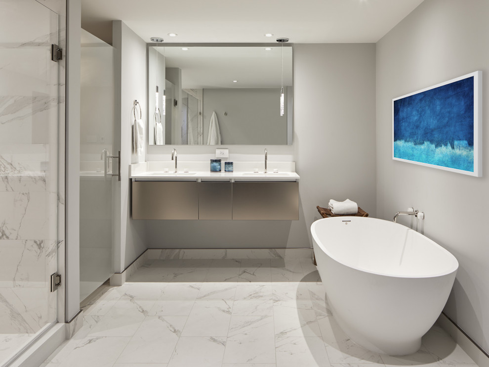 Inspiration for a contemporary master bathroom in DC Metro with grey cabinets, a freestanding tub, a double shower, white tile, porcelain tile, porcelain floors, a wall-mount sink, white floor, a hinged shower door, white benchtops, an enclosed toilet, a double vanity and a floating vanity.