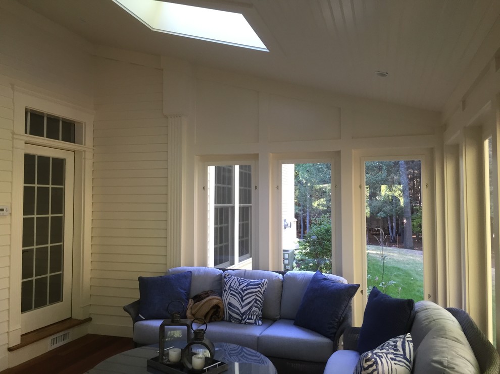 Photo of a mid-sized traditional sunroom in Boston with a skylight, brown floor, dark hardwood floors and no fireplace.