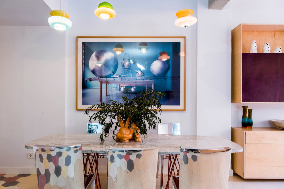 This is an example of a mid-sized eclectic open plan dining in Madrid with white walls and no fireplace.