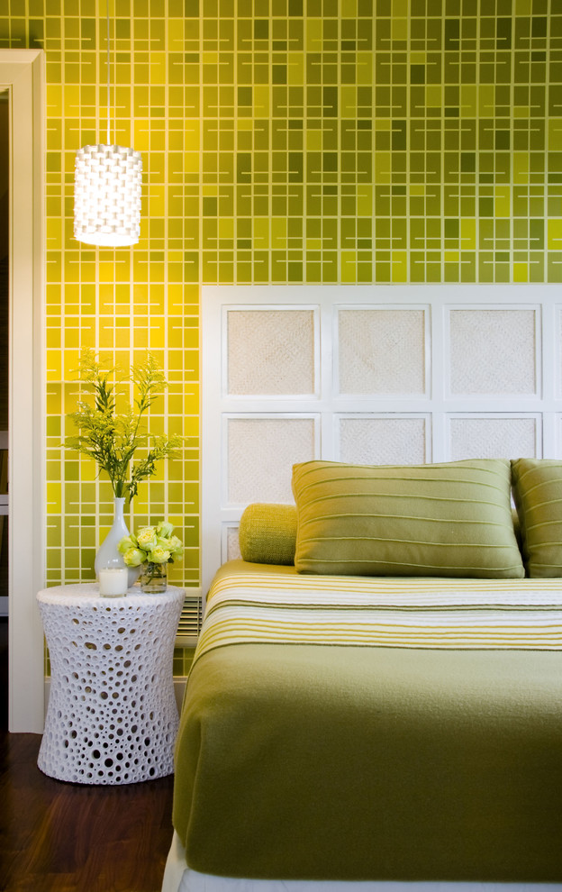 This is an example of a midcentury master bedroom in New York with green walls and dark hardwood floors.