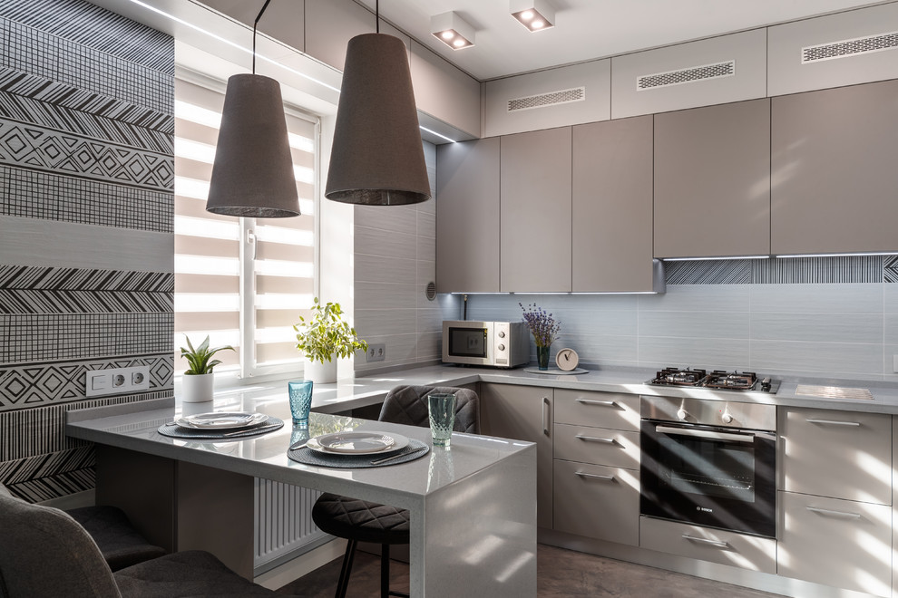 Inspiration for a small contemporary u-shaped kitchen in Other with flat-panel cabinets, grey cabinets, stainless steel appliances, a peninsula, grey floor and grey benchtop.
