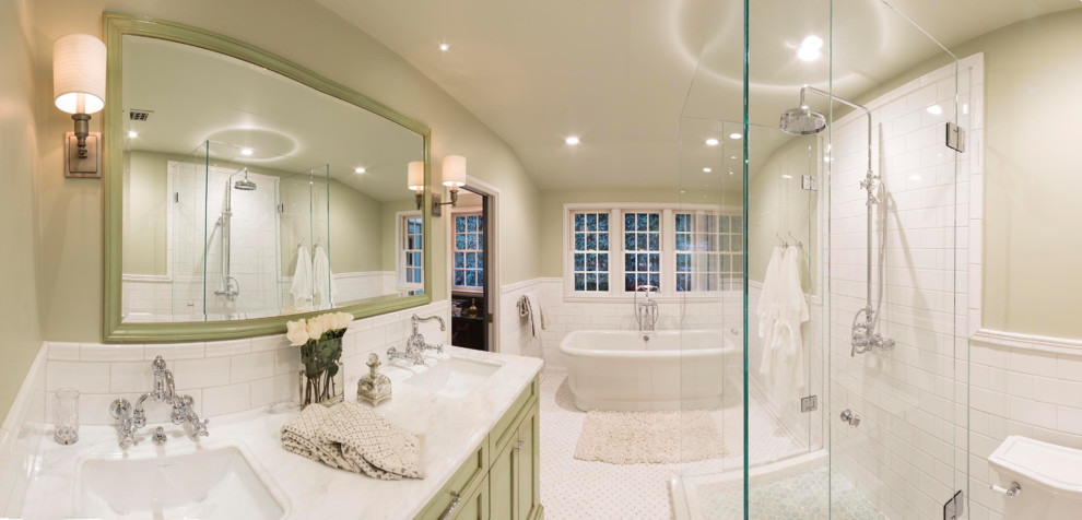 Mid-sized master white tile and ceramic tile mosaic tile floor freestanding bathtub photo in Santa Barbara with an undermount sink, recessed-panel cabinets, green cabinets, marble countertops, a one-piece toilet and green walls