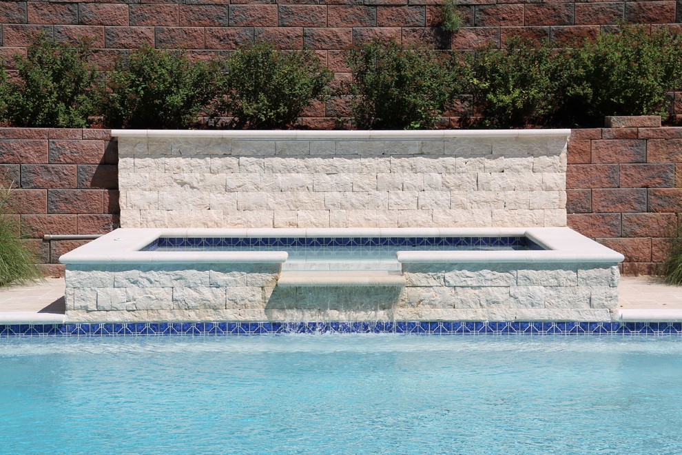 Example of a large backyard stone lap hot tub design in New York