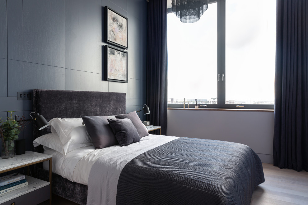 Contemporary bedroom in London with grey walls, medium hardwood floors and brown floor.