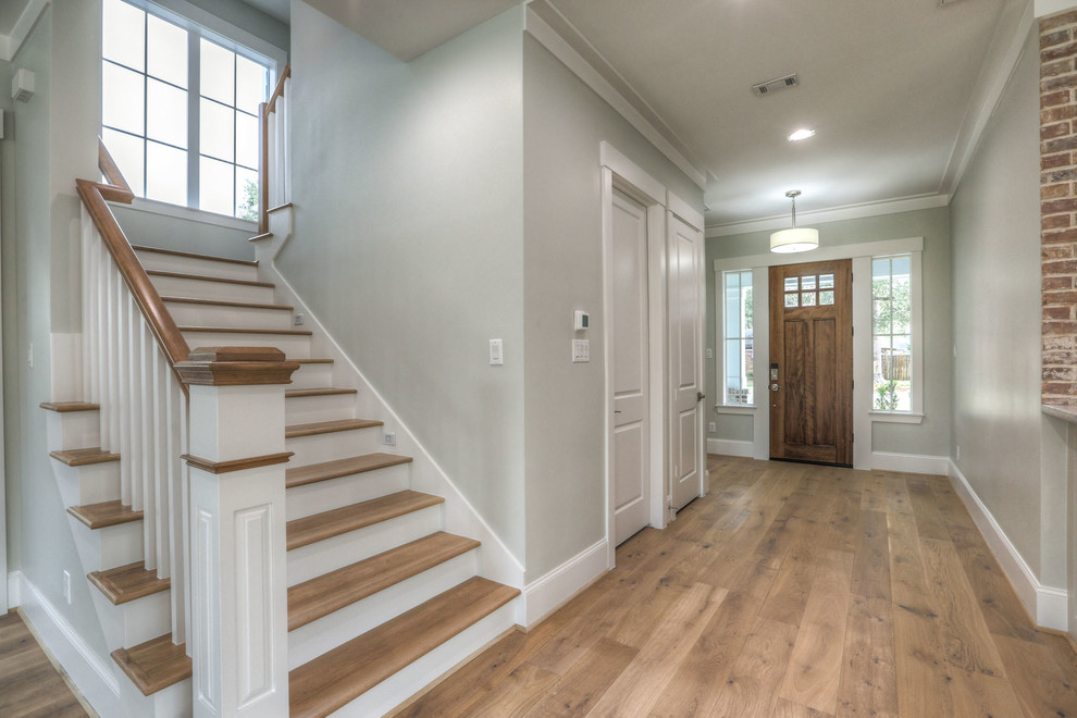 Single front door - large transitional light wood floor and beige floor single front door idea in Houston with a dark wood front door