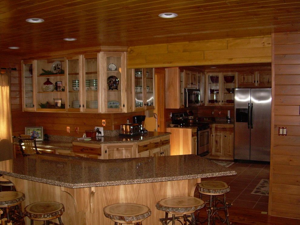 Inspiration for a mid-sized rustic u-shaped medium tone wood floor and brown floor open concept kitchen remodel with glass-front cabinets, light wood cabinets, granite countertops, brown backsplash, wood backsplash, stainless steel appliances and an island