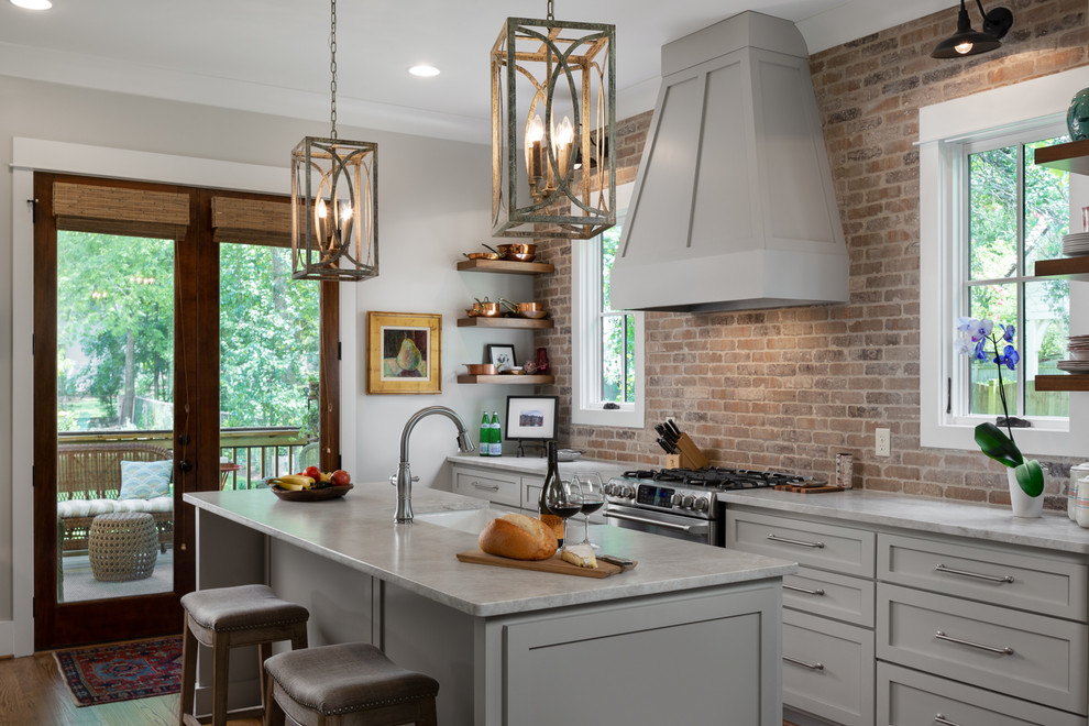 Design ideas for a traditional kitchen in Birmingham with a farmhouse sink, marble benchtops, brick splashback, stainless steel appliances, with island, shaker cabinets, grey cabinets and grey benchtop.