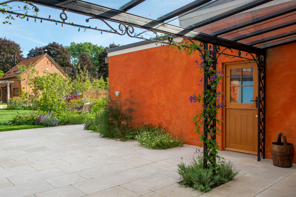 This is an example of a mid-sized mediterranean backyard garden in Wiltshire.