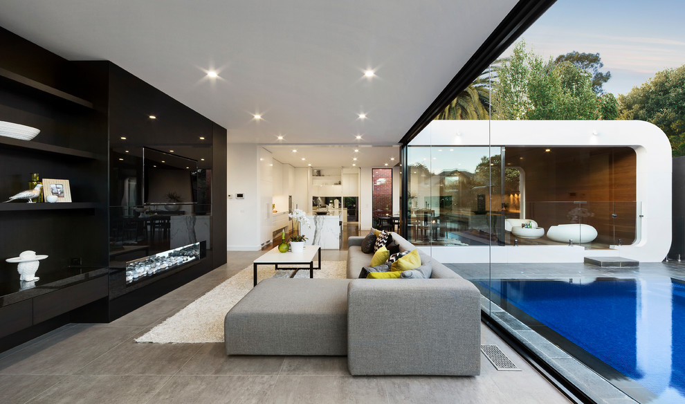 Mid-sized contemporary open concept living room in Melbourne with a ribbon fireplace, a wall-mounted tv and black walls.