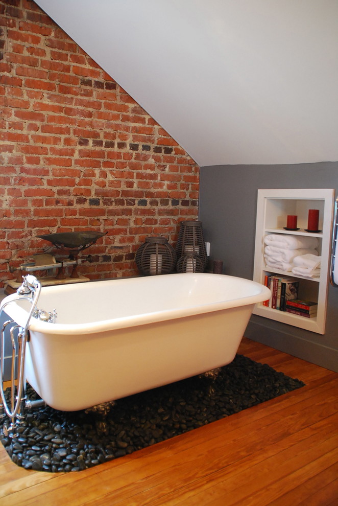 Design ideas for a large industrial master bathroom in DC Metro with an undermount sink, a claw-foot tub, a one-piece toilet, flat-panel cabinets, grey cabinets, marble benchtops, grey walls, light hardwood floors and an alcove shower.
