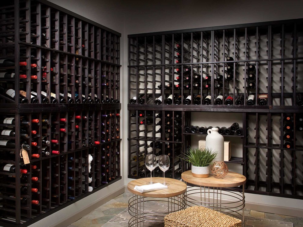 Design ideas for a beach style wine cellar in Seattle with storage racks and limestone floors.