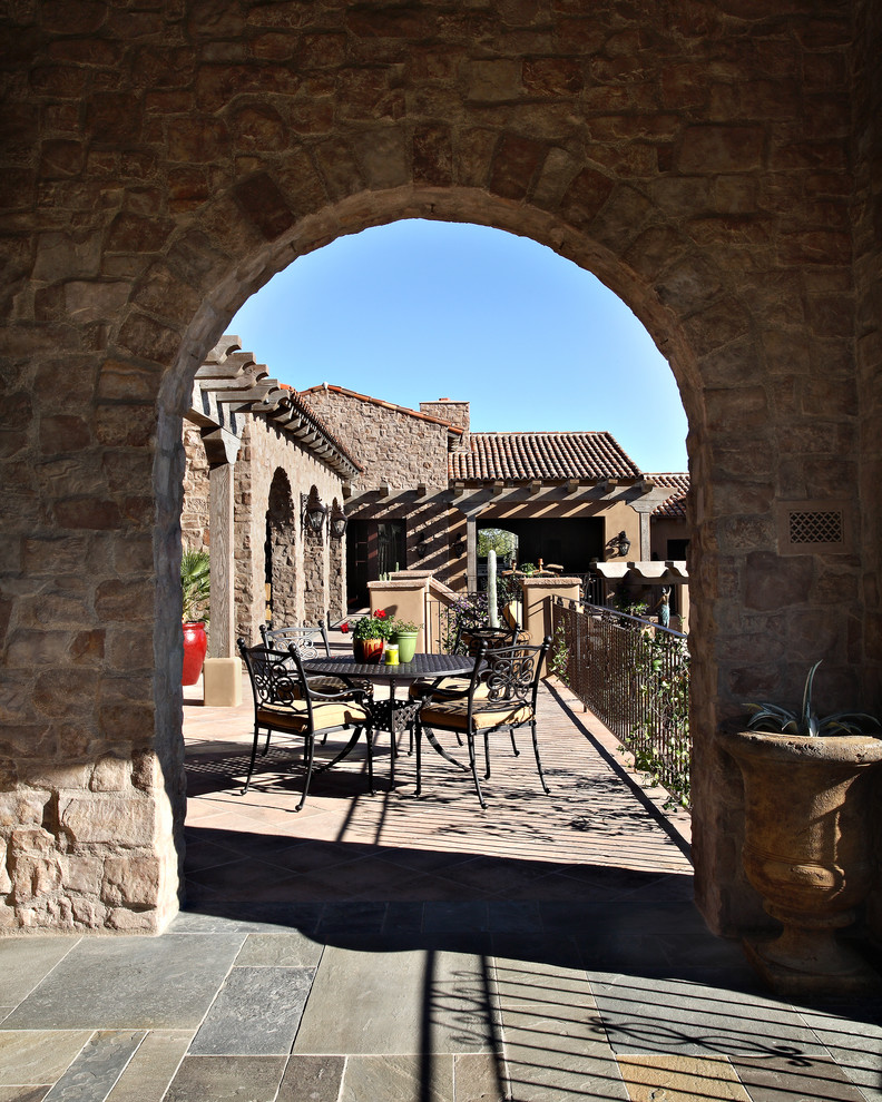 Mediterranean patio in Phoenix with a pergola.