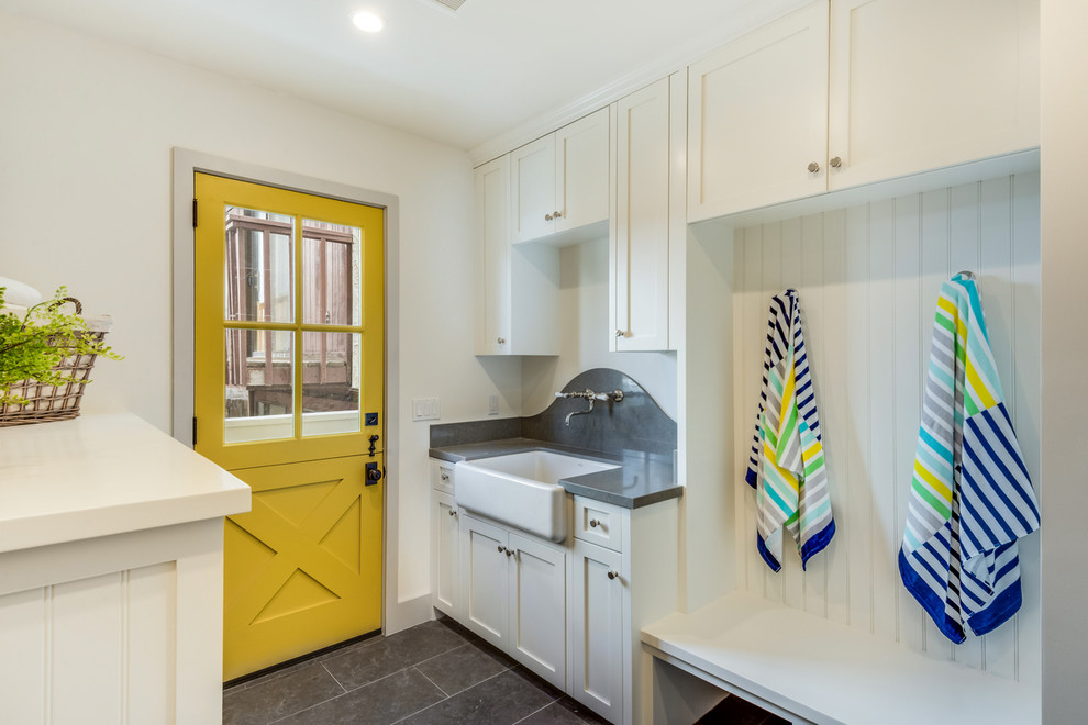 Beach style mudroom in Los Angeles with white walls, a dutch front door, a yellow front door and grey floor.