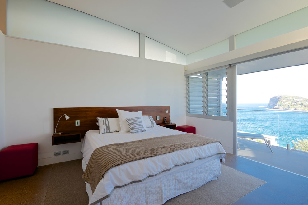 Photo of a mid-sized contemporary master bedroom in Sydney with white walls, dark hardwood floors and brown floor.