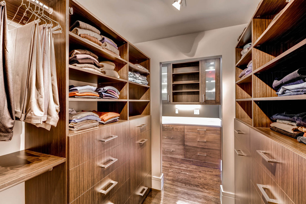 Inspiration for a large transitional gender-neutral ceramic tile walk-in closet remodel in Denver with shaker cabinets and dark wood cabinets