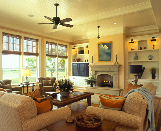 This is an example of a mid-sized traditional formal open concept living room in Charleston with yellow walls, dark hardwood floors, a standard fireplace, a stone fireplace surround, a built-in media wall, brown floor and timber.