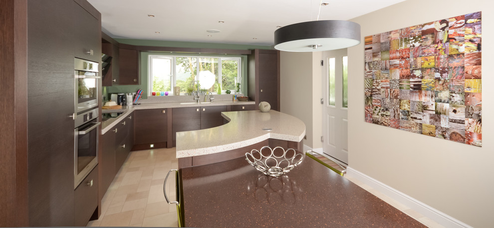 Inspiration for a mid-sized contemporary single-wall eat-in kitchen in Manchester with an undermount sink, flat-panel cabinets, dark wood cabinets, solid surface benchtops, stainless steel appliances and with island.