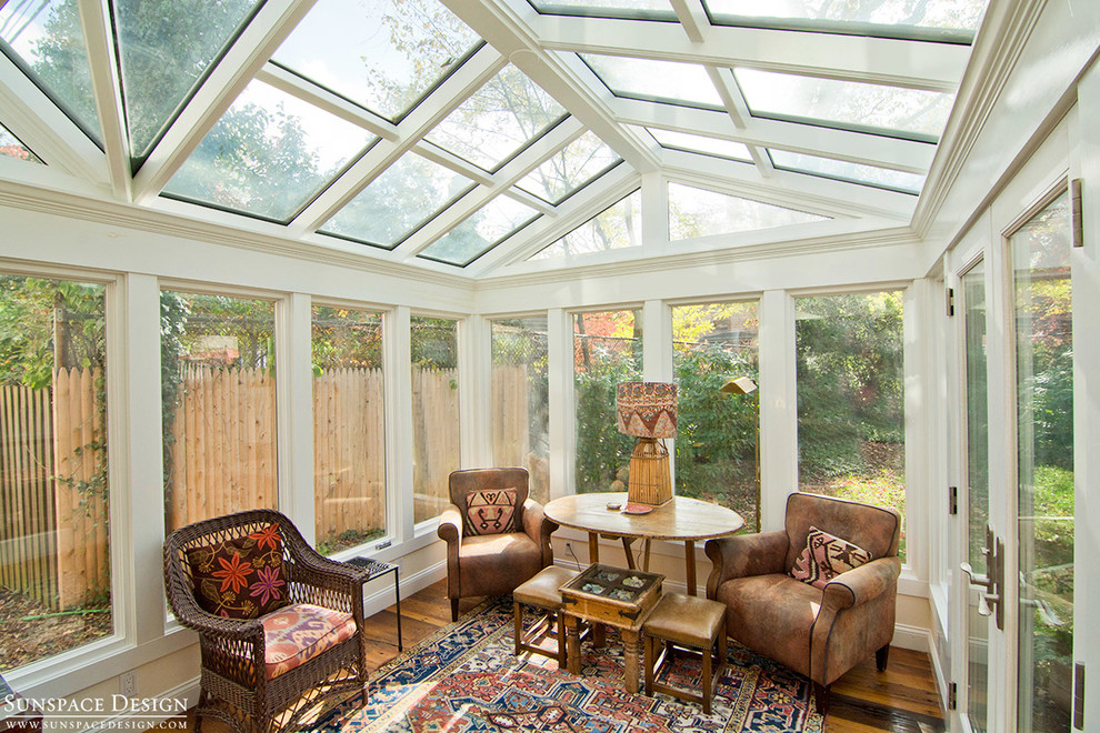 Mid-sized country sunroom in Boston with medium hardwood floors, no fireplace and a glass ceiling.