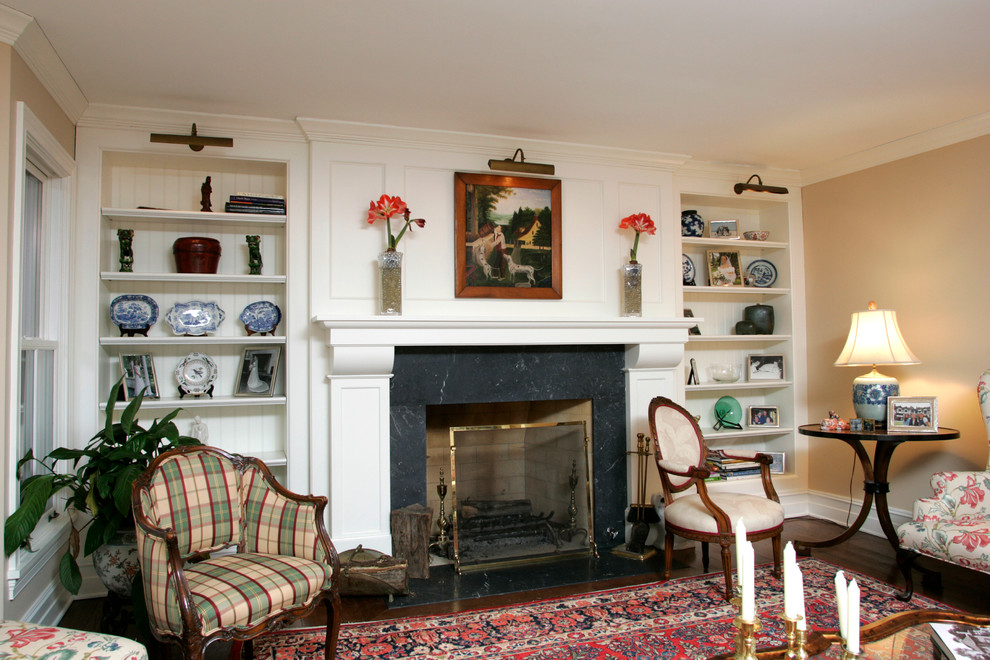 Inspiration for a mid-sized traditional enclosed living room in Chicago with a library, beige walls, dark hardwood floors, a standard fireplace and a stone fireplace surround.