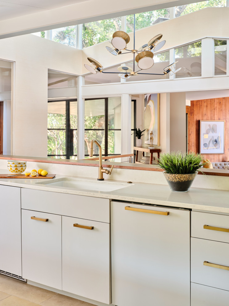 Photo of a large midcentury galley open plan kitchen in Austin with an undermount sink, flat-panel cabinets, grey cabinets, quartz benchtops, multi-coloured splashback, marble splashback, panelled appliances, limestone floors, a peninsula, grey floor, white benchtop and exposed beam.