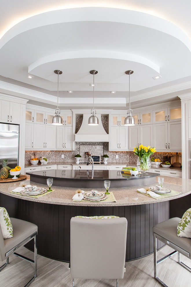 This is an example of a large transitional galley eat-in kitchen in Toronto with raised-panel cabinets, white cabinets and with island.