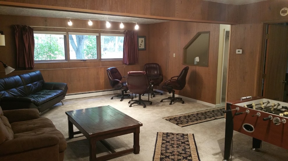 This is an example of a mid-sized traditional look-out basement in Other with brown walls, carpet, no fireplace and beige floor.