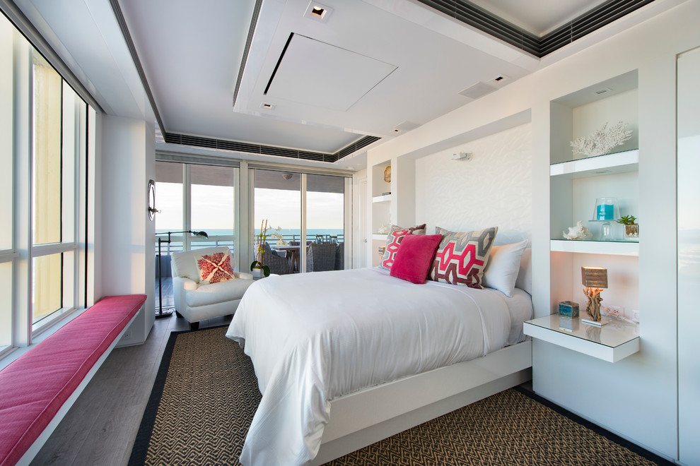 Mid-sized trendy guest dark wood floor and brown floor bedroom photo in Miami with white walls and no fireplace