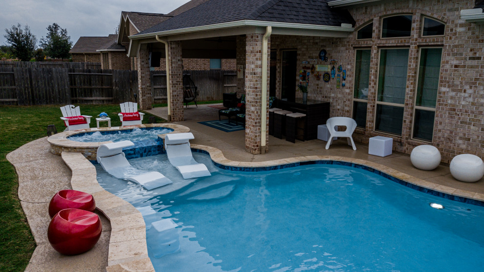 This is an example of a mid-sized tropical backyard custom-shaped pool in Houston.