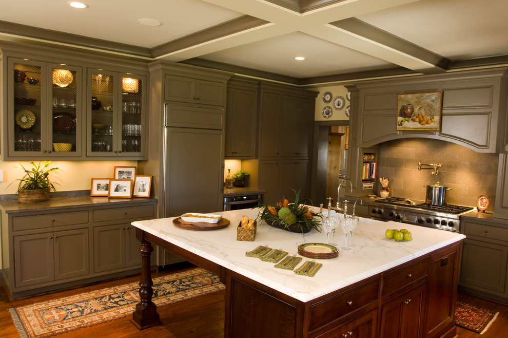 Design ideas for a large traditional l-shaped open plan kitchen in Charleston with beaded inset cabinets, green cabinets, grey splashback, panelled appliances, medium hardwood floors and with island.