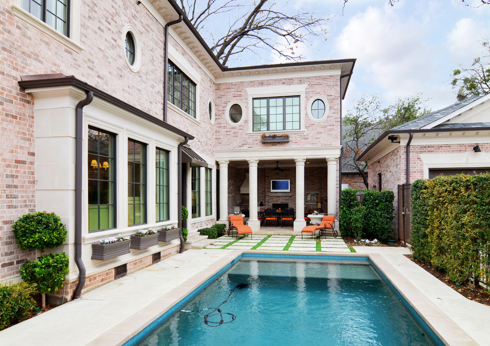This is an example of a mid-sized traditional backyard rectangular lap pool in Dallas with stamped concrete.