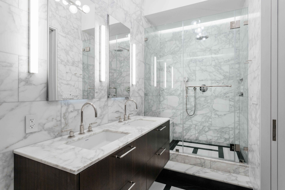 Inspiration for a mid-sized contemporary master bathroom in New York with flat-panel cabinets, an alcove shower, marble, grey walls, marble benchtops, a hinged shower door, white benchtops, white tile, an undermount sink, dark wood cabinets, a shower seat, a double vanity and a floating vanity.