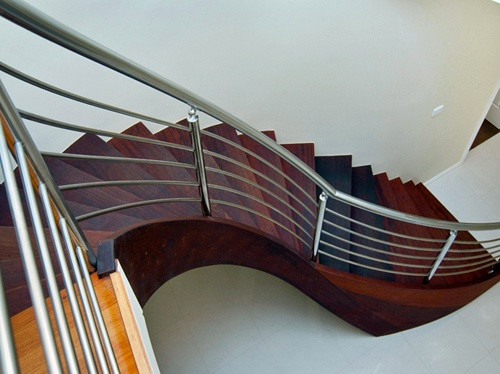 Photo of a large contemporary wood curved staircase in Central Coast.