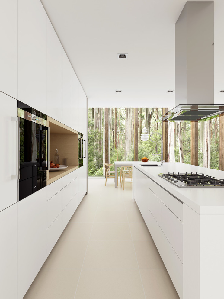 Photo of a mid-sized modern galley eat-in kitchen in Sydney with with island, white cabinets, quartz benchtops, stainless steel appliances, porcelain floors and an undermount sink.