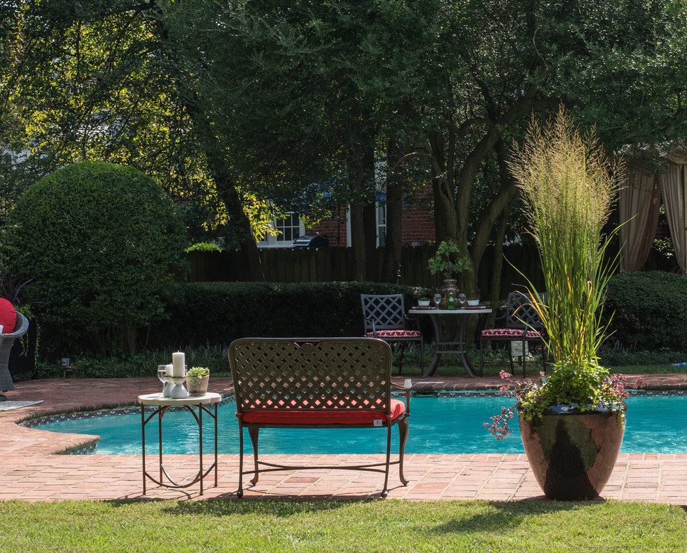 Design ideas for a mid-sized traditional backyard pool in Richmond with brick pavers.