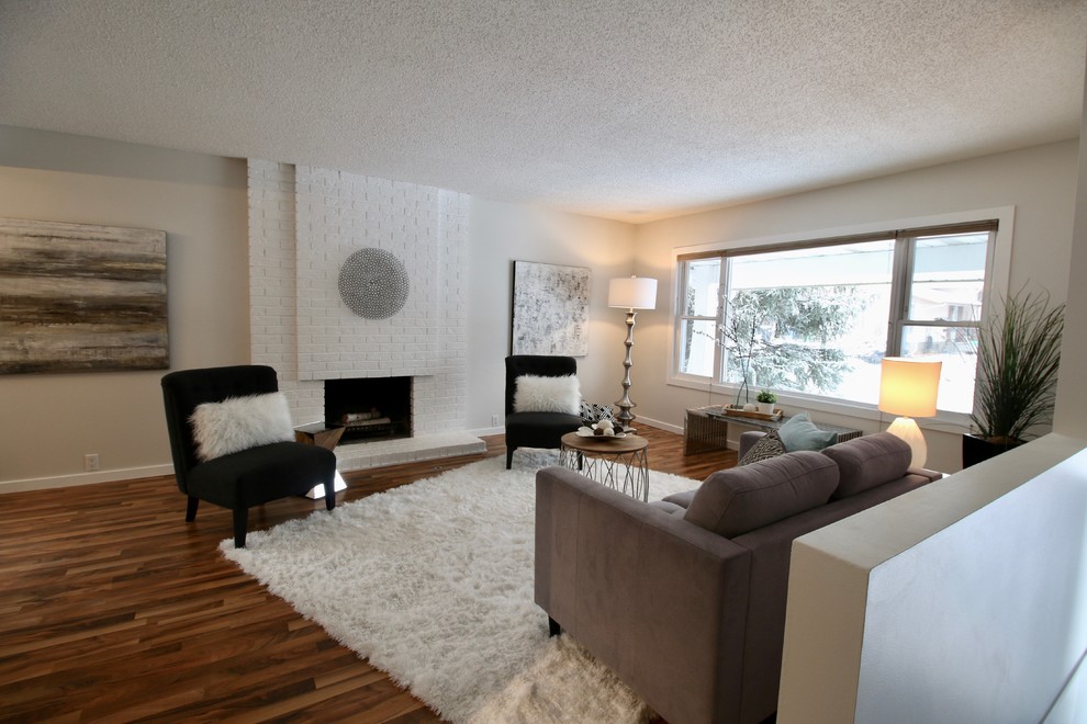 Photo of a transitional living room in Calgary with a brick fireplace surround.