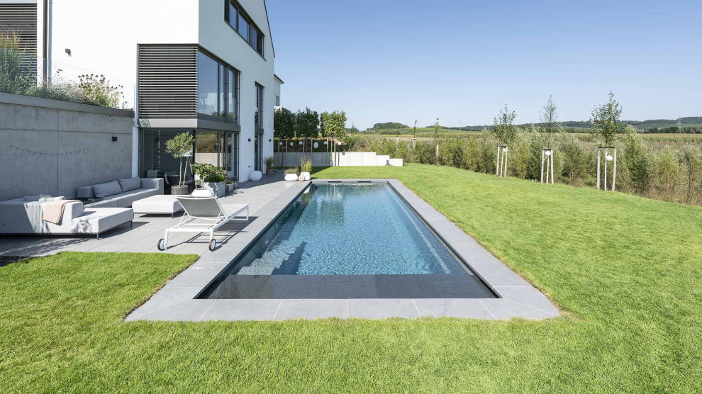 Geräumiger, Gefliester Moderner Pool neben dem Haus in rechteckiger Form in Stuttgart