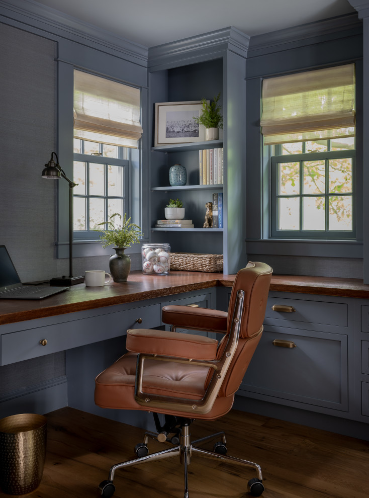 Inspiration for a mid-sized country built-in desk medium tone wood floor and brown floor study room remodel in Boston with blue walls