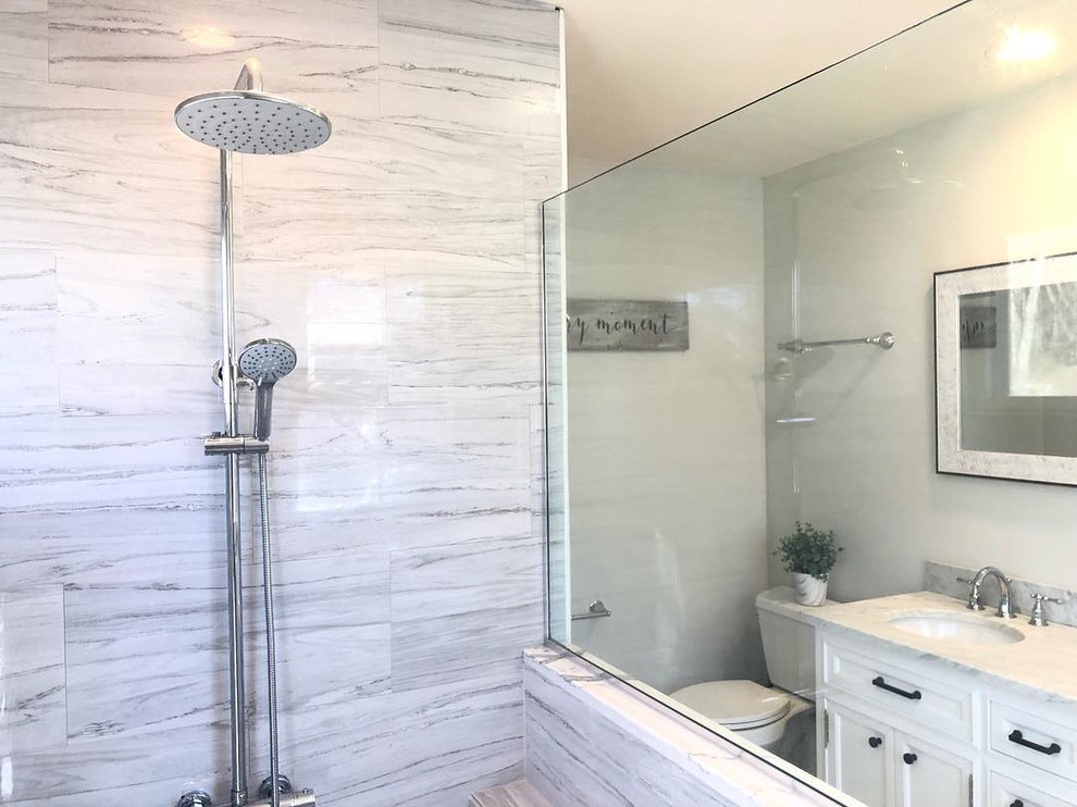 Design ideas for a large transitional master wet room bathroom in Boston with shaker cabinets, white cabinets, a freestanding vanity, gray tile, stone tile, marble benchtops, grey benchtops, a single vanity, a two-piece toilet, white walls, an undermount sink and a hinged shower door.