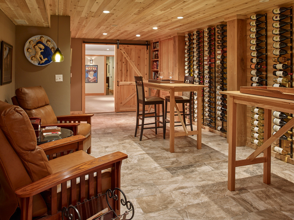 This is an example of a traditional wine cellar in Boston with travertine floors, display racks and grey floor.