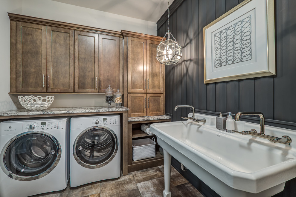 This is an example of a large transitional utility room in Other with an utility sink, granite benchtops, grey walls, a side-by-side washer and dryer, recessed-panel cabinets and dark wood cabinets.