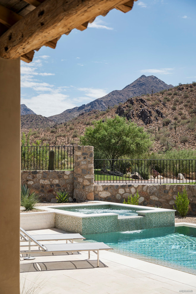 This is an example of a large backyard rectangular lap pool in Phoenix with a hot tub and tile.