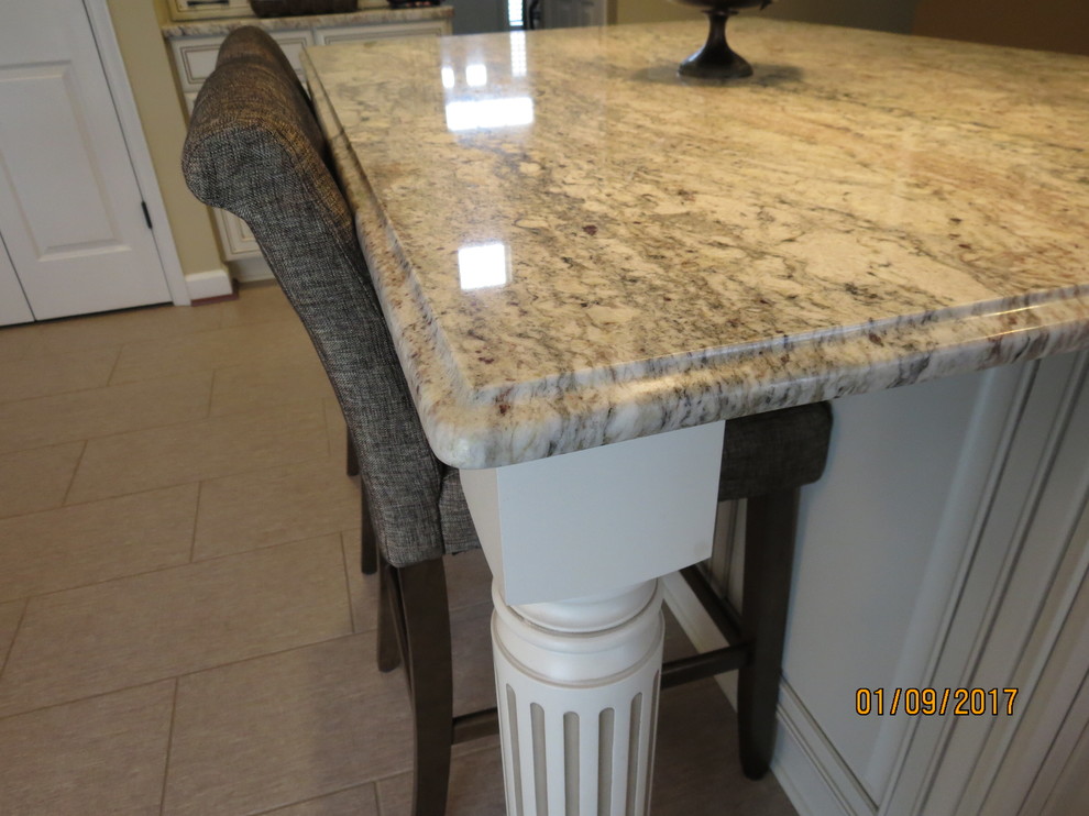 Mid-sized transitional l-shaped ceramic tile eat-in kitchen photo in DC Metro with an undermount sink, raised-panel cabinets, distressed cabinets, granite countertops, white backsplash, porcelain backsplash, stainless steel appliances and an island