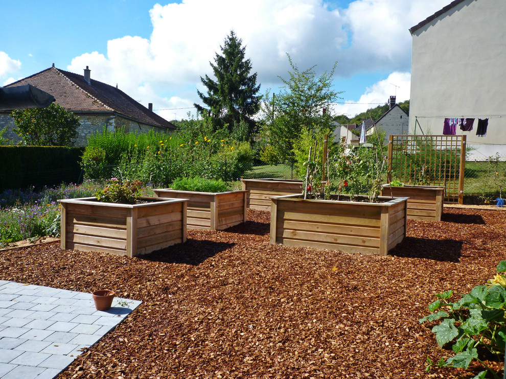 Mid-sized contemporary backyard garden in Dijon with a vegetable garden and mulch.