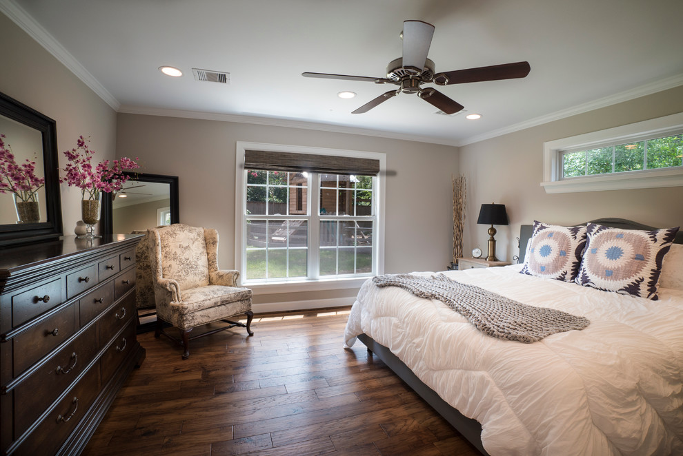 Design ideas for a mid-sized traditional master bedroom in Houston with beige walls and medium hardwood floors.