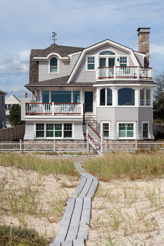 Inspiration for a beach style three-storey grey exterior in Boston with wood siding and a gambrel roof.