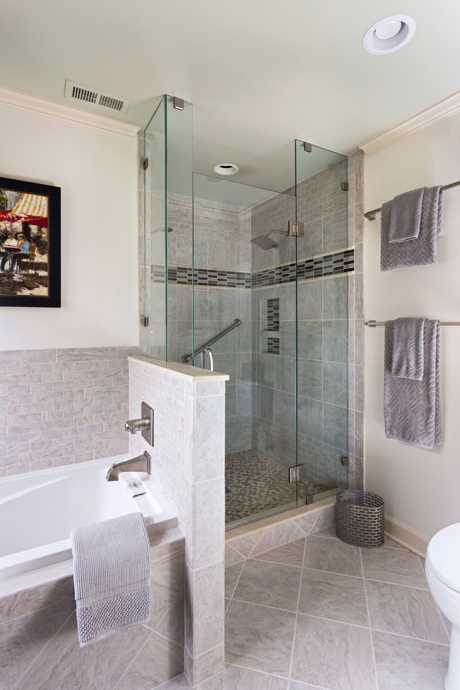 This is an example of a mid-sized traditional master bathroom in Charlotte with an undermount sink, shaker cabinets, medium wood cabinets, marble benchtops, an alcove tub, an alcove shower, a two-piece toilet, gray tile, mosaic tile, beige walls and travertine floors.