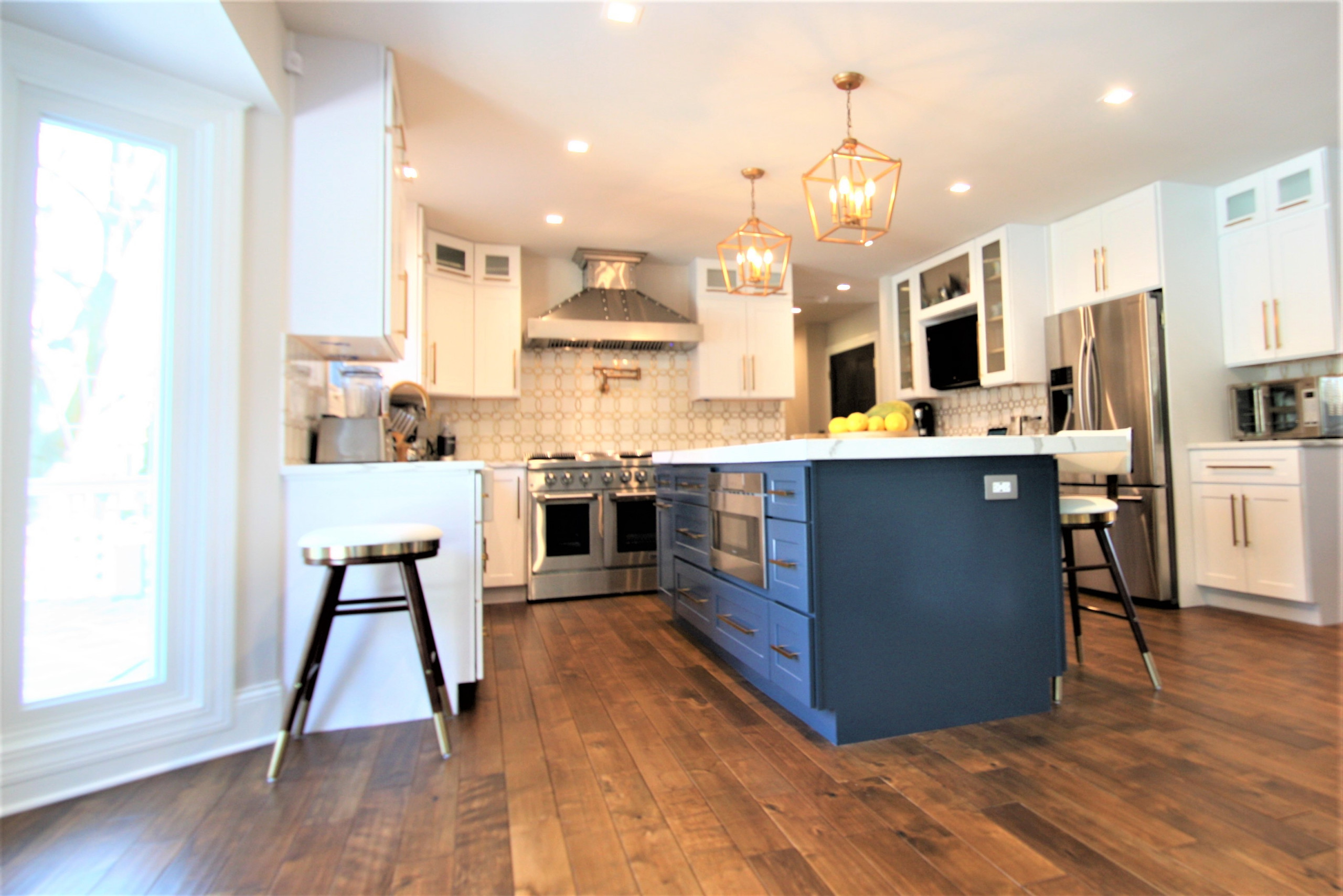 Modern kitchen design and remodel. Shaker style cabinets in white and blue.