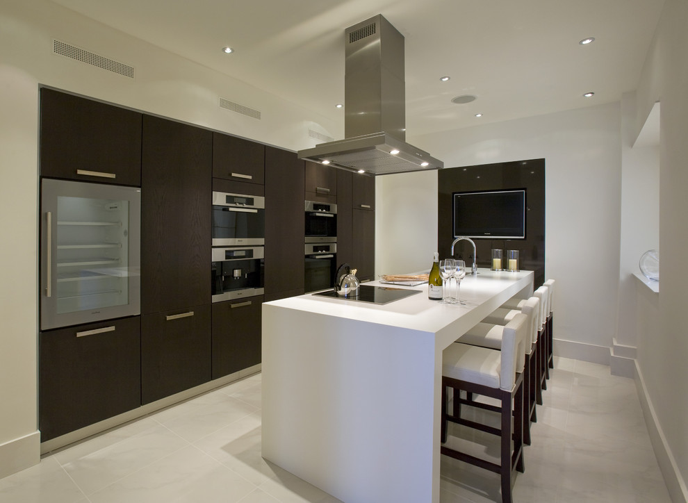 Inspiration for a modern kitchen in DC Metro with stainless steel appliances, porcelain floors, beige floor, flat-panel cabinets, dark wood cabinets, quartz benchtops and with island.