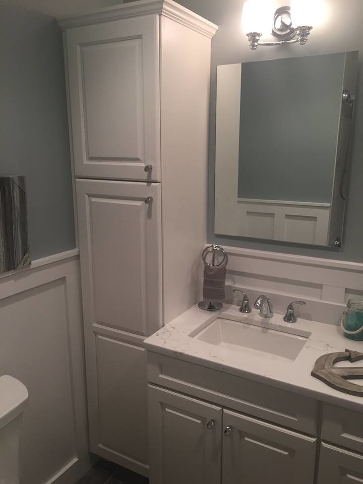 Inspiration for a mid-sized traditional 3/4 bathroom in New York with raised-panel cabinets, white cabinets, an alcove tub, a shower/bathtub combo, a two-piece toilet, white tile, green walls, porcelain floors, an undermount sink, engineered quartz benchtops, grey floor and a shower curtain.