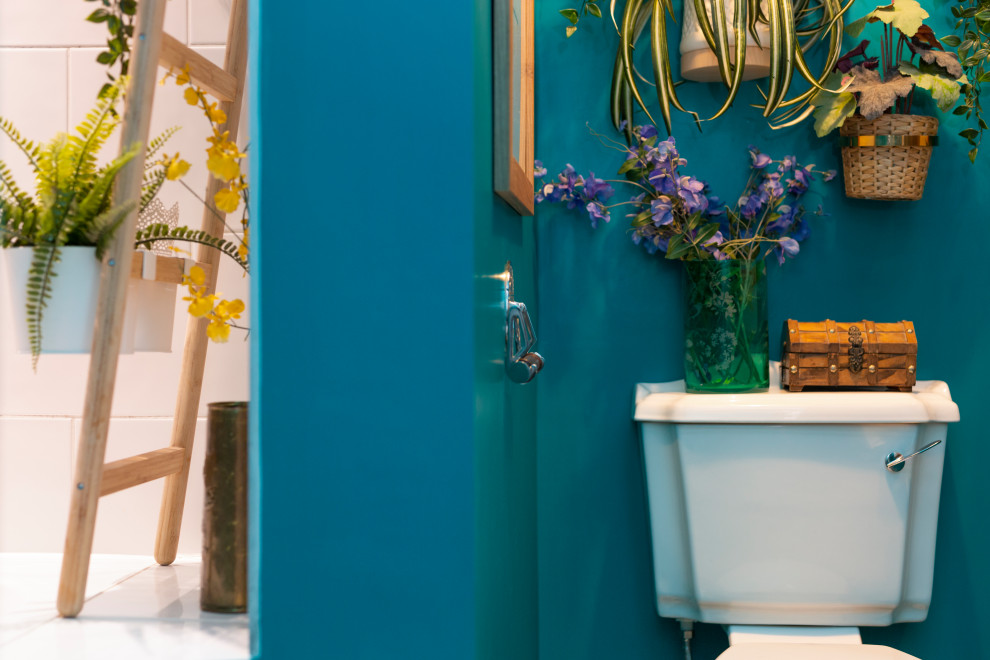 Photo of a mid-sized eclectic kids bathroom in Edinburgh with a drop-in tub, a shower/bathtub combo, a one-piece toilet, black and white tile, ceramic tile, green walls, linoleum floors, a wall-mount sink, tile benchtops, grey floor, a hinged shower door and white benchtops.